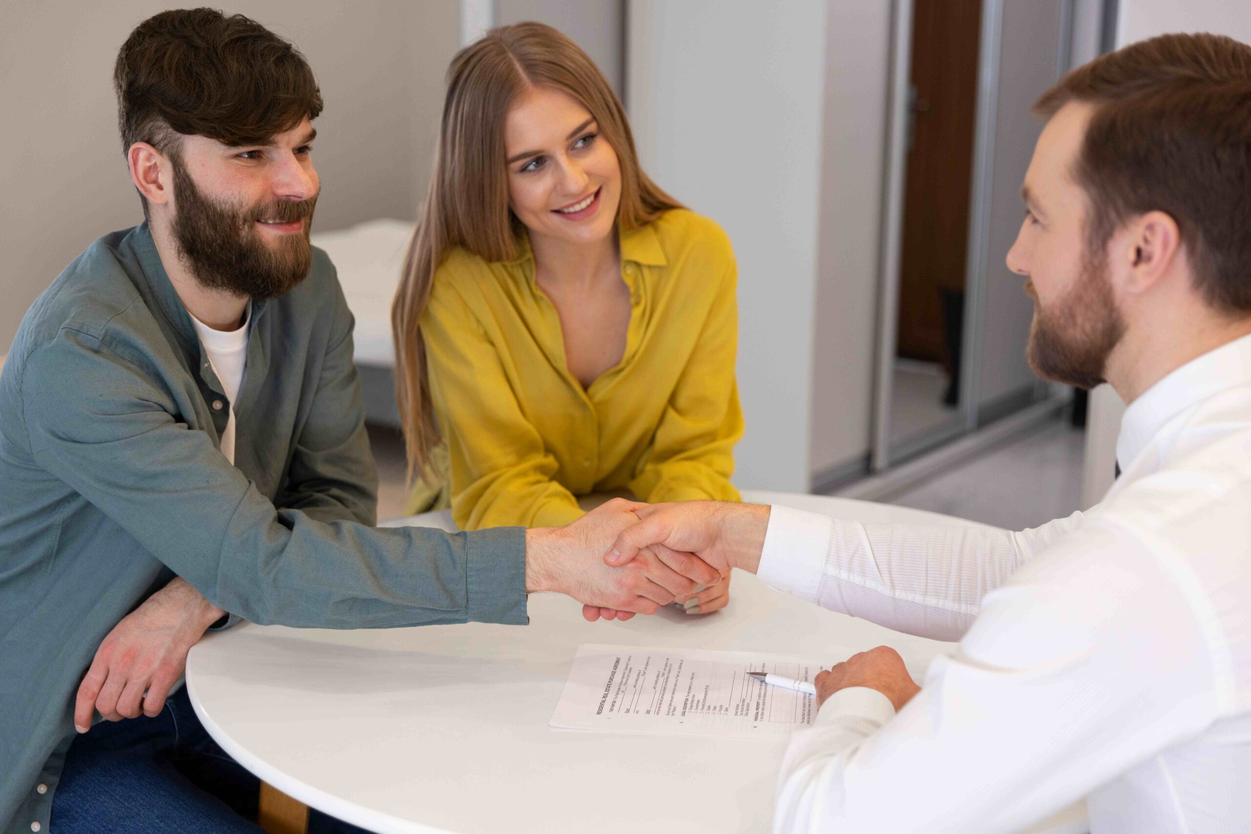 male real estate agent doing business showing house potential buying couple (1)